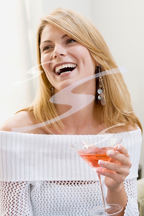 Happy woman holding cocktail
