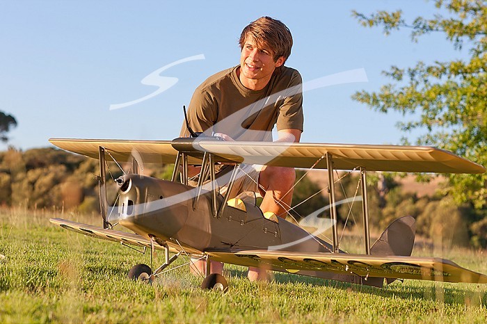 Man playing with toy airplane in park