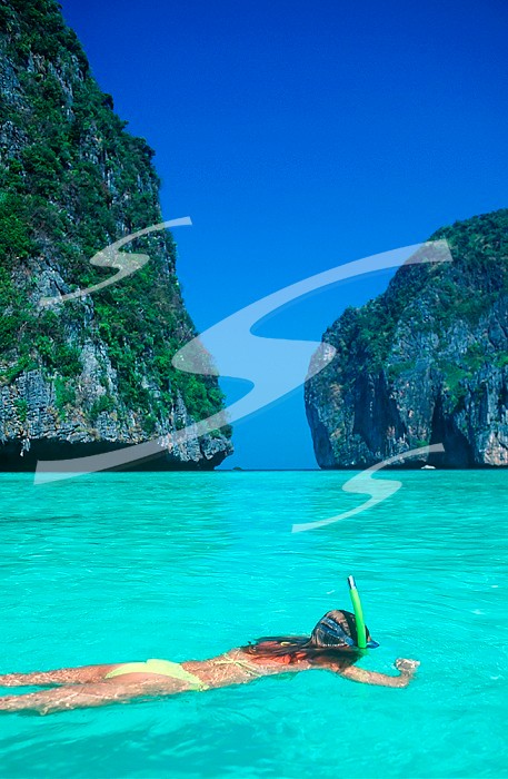 South East Asia - Thailand   - Ko Phi Phi (Island) - limestone cliffs, snorkeler. South East Asia - Thailand - Ko Phi Phi (Island) - limestone cliffs, snorkeler