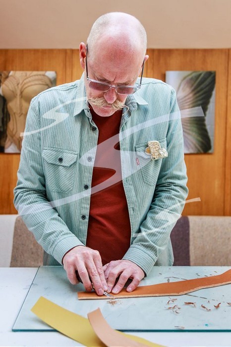 London, England, UK, 2 March 2023 - Keir Malem, from British artists & designers duo Whitaker Malem, cuts leather at their studio in North London.. Whitaker Malem