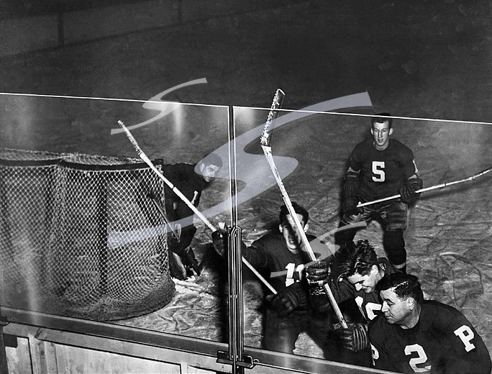 Pittsburgh, Pennsylvania, February 15, 1946 Herculite tempered plate glass, made by the Pittsburgh Plate Glass Company, now offers full vision and total safety to hockey fans at the Pittsburgh Hornet’s home games. The Herculite glass is four to five times stronger than heavy plate glass. It can withstand the bone-crushing shock of the furious ice sport.. Safety Views For Hockey Fans