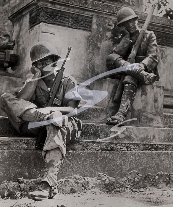 Brolo, Sicily, Italy, September 23, 1943 Sargent. Norwood Dorman, from Benson, North Carolina., foot-sore, tired and dirty from his march to Brolo, rests at the base of a memorial to Italian soldiers of World War I.. Soldiers From Two World Wars