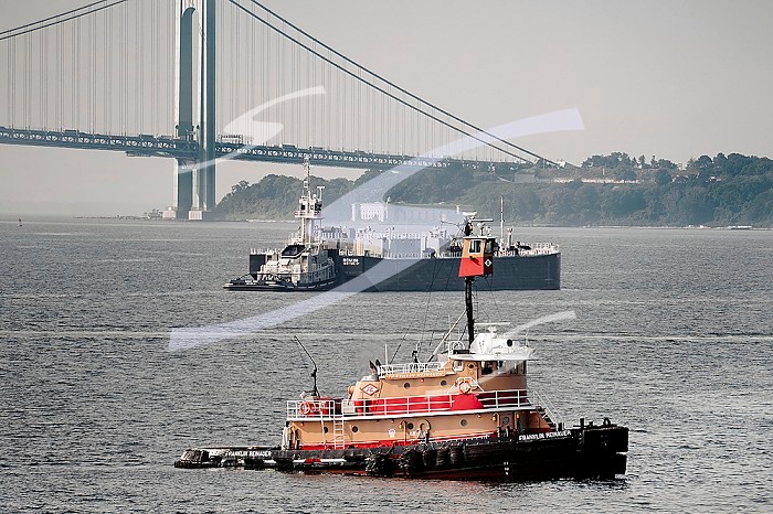 Tugboat and barge in upper New York Bay with Verrazzano-Narrows Bridge and Staten Island in background< New York City, New York, USA.. Tugboat and barge in upper New York Bay with Verrazzano-Narrows Bridge and Staten Island in background< New York City, New York, USA