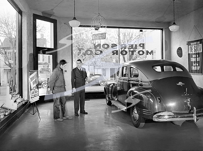 Pierson Motor Company showroom owned by Al Pierson (right) who is showing his one second-hand car to local farmer. Before World War II there always were three brand new cars in his showroom, now during the war, the chief business is repairing, Lititz, Pennsylvania, USA, Marjory Collins, U.S. Office of War Information, November 1942. . Pierson Motor Company showroom owned by Al Pierson (right) who is showing his one second-hand car to local farmer. Before World War II there always were three brand new cars in his showroom, now during the war, the chief business is repairing, Lititz, Pennsylvania, USA, Marjory Collins, U.S. Office of War Information, November 1942